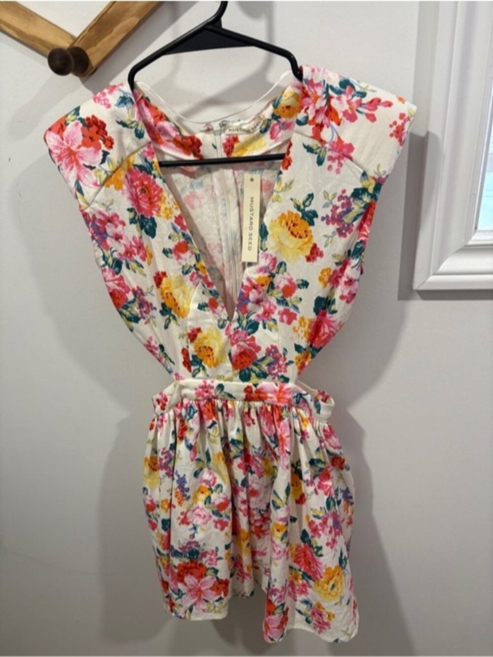 Mustard Seed floral mini dress featuring side cutouts and a v-neckline.